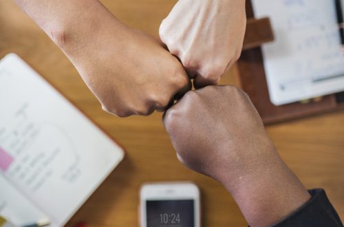 Diverse people giving a fist bump